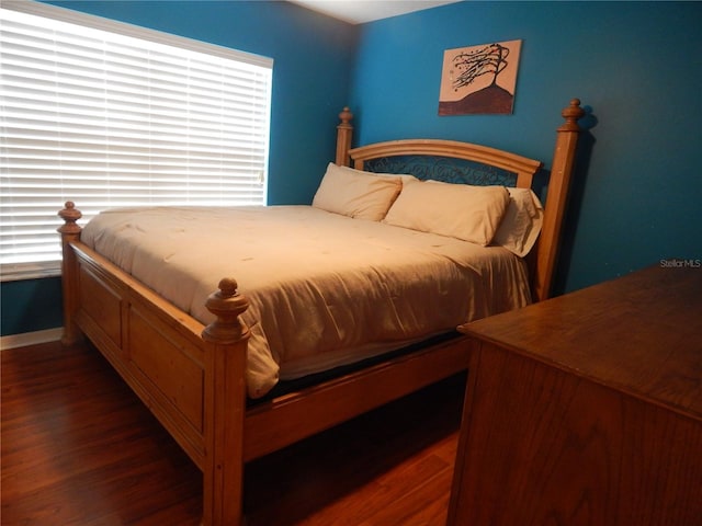 bedroom featuring dark hardwood / wood-style flooring