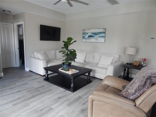 living room with light hardwood / wood-style floors and ceiling fan