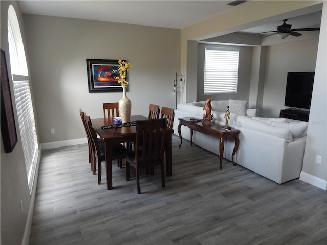 dining room with hardwood / wood-style floors and ceiling fan