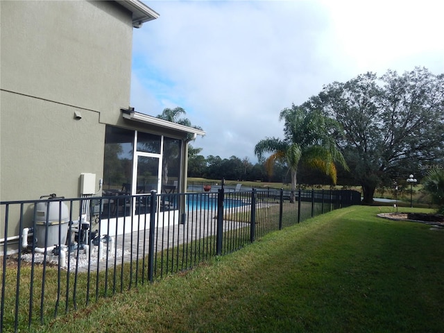 view of pool featuring a sunroom, a patio, and a lawn