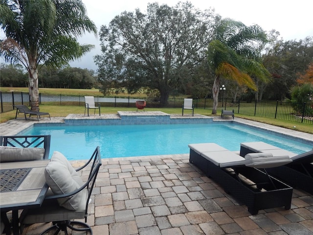 view of pool with a patio area and a yard