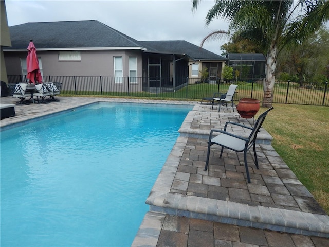 view of swimming pool featuring a patio area and a yard