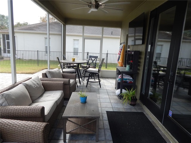 sunroom / solarium featuring ceiling fan