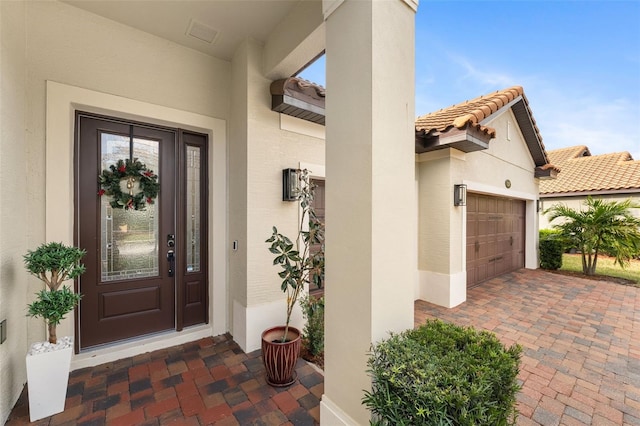 view of exterior entry with a garage