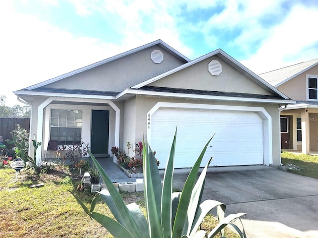 single story home featuring a garage and a front yard