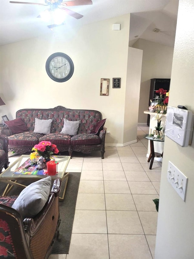 tiled living room with ceiling fan and lofted ceiling