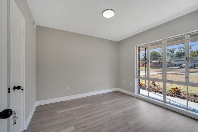 unfurnished room featuring light hardwood / wood-style floors