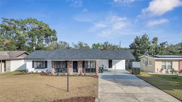 ranch-style house featuring a front yard, a porch, and a carport