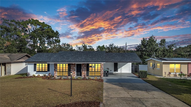 single story home featuring a porch and a yard