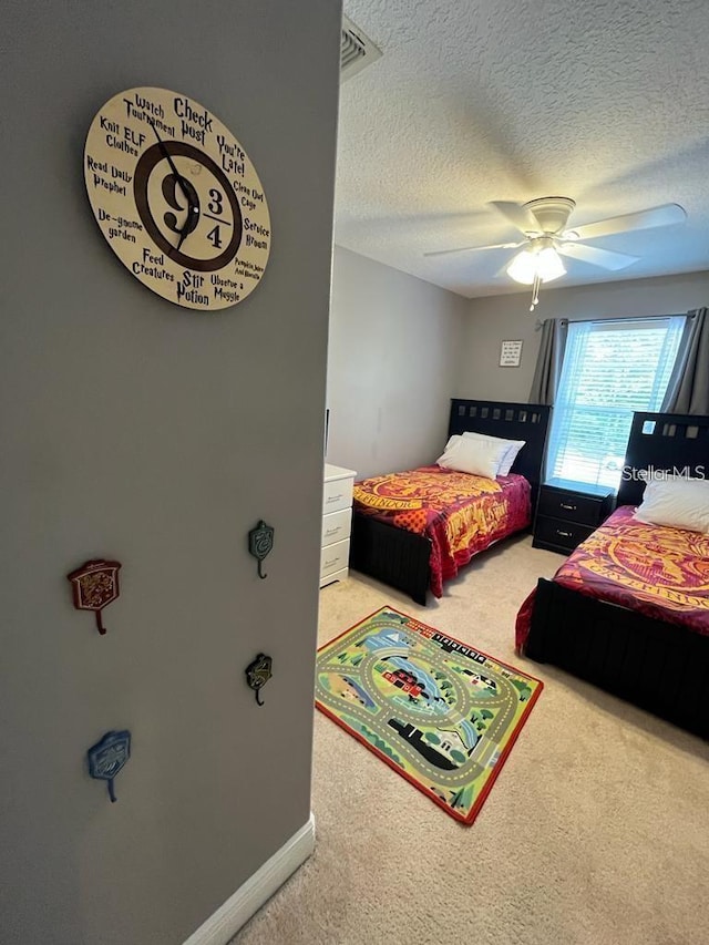 bedroom with carpet flooring, a textured ceiling, and ceiling fan