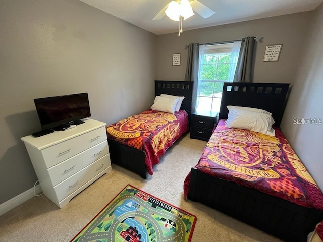 bedroom featuring ceiling fan and light colored carpet