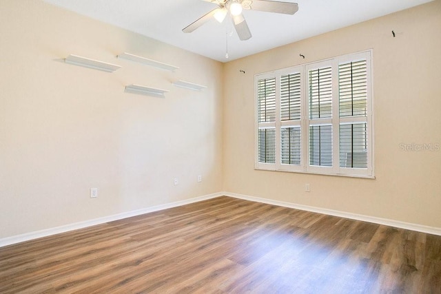 spare room with ceiling fan and wood-type flooring