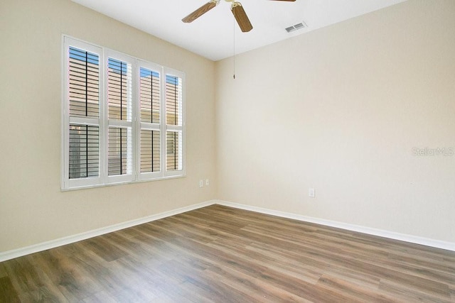 spare room with ceiling fan and wood-type flooring