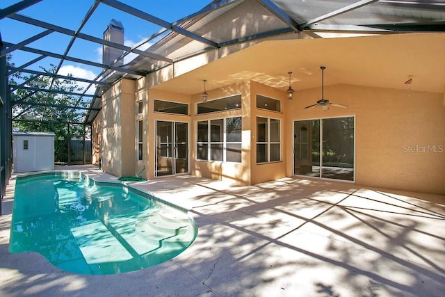 view of swimming pool featuring a patio area, ceiling fan, and glass enclosure