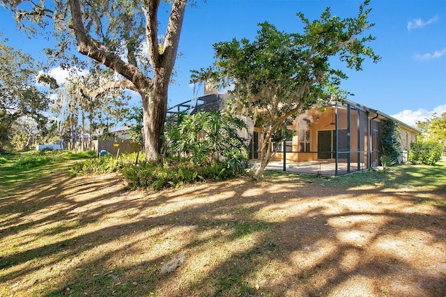 view of yard with glass enclosure