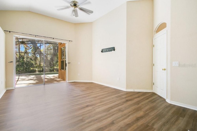 spare room with ceiling fan, wood-type flooring, and lofted ceiling