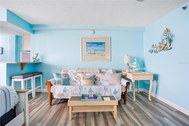 living room with hardwood / wood-style floors and a textured ceiling