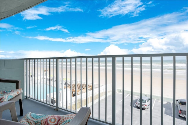 balcony with a view of the beach and a water view