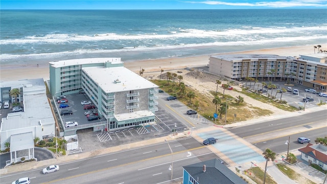 drone / aerial view featuring a water view and a beach view