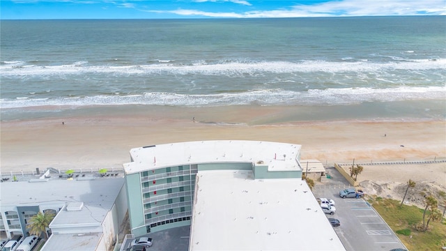 aerial view with a water view and a beach view