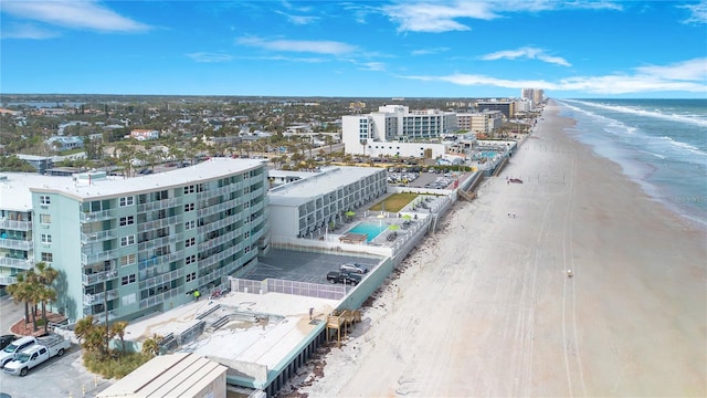 birds eye view of property featuring a view of the beach and a water view