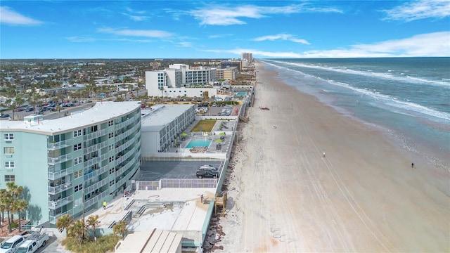 aerial view with a water view and a beach view