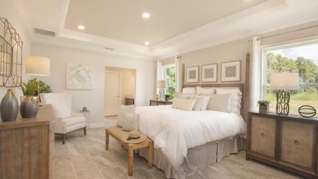 bedroom with a tray ceiling and crown molding