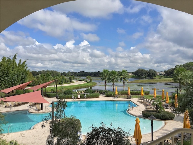 community pool featuring a patio area and a water view