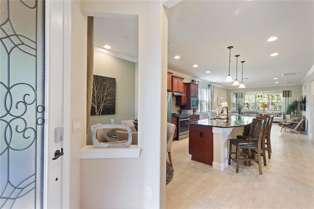 kitchen with a sink, open floor plan, appliances with stainless steel finishes, dark countertops, and a center island with sink