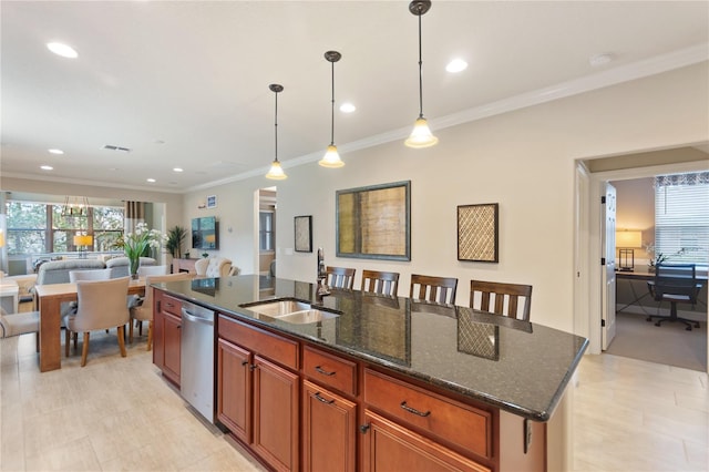 kitchen featuring a kitchen island with sink, a sink, hanging light fixtures, and dishwasher