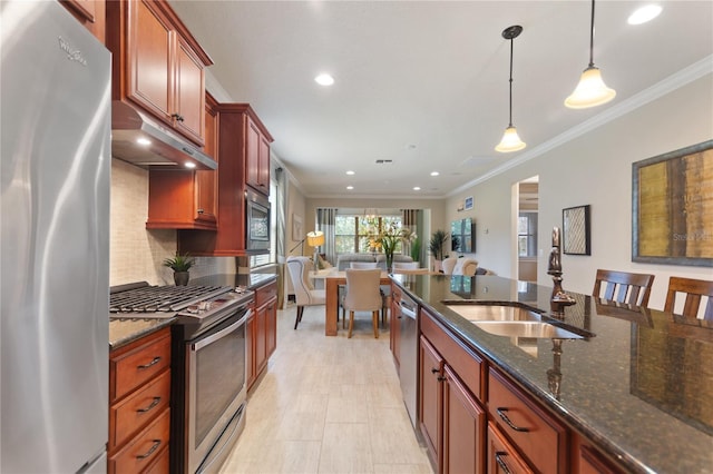 kitchen featuring ornamental molding, decorative light fixtures, stainless steel appliances, under cabinet range hood, and a sink