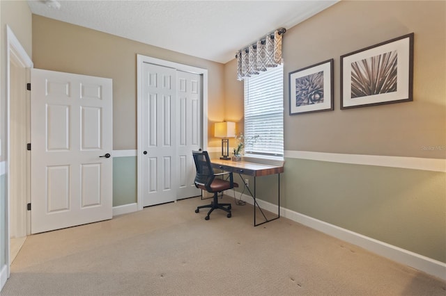 office with light carpet and baseboards