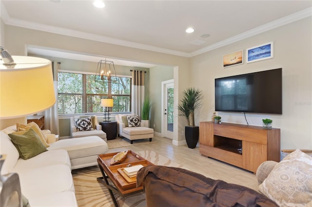 living room featuring baseboards, ornamental molding, a notable chandelier, and recessed lighting