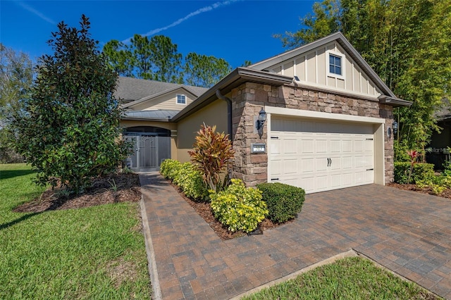 view of front of property with a garage, stone siding, board and batten siding, and decorative driveway