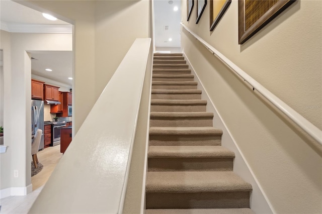 stairway featuring ornamental molding and recessed lighting