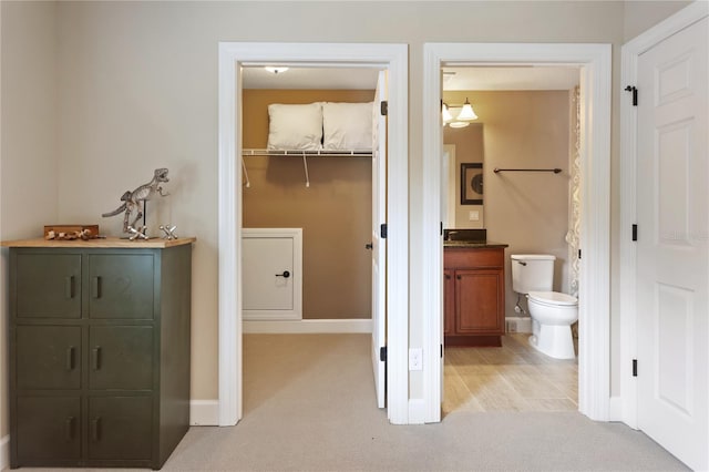 bathroom with vanity, toilet, and baseboards