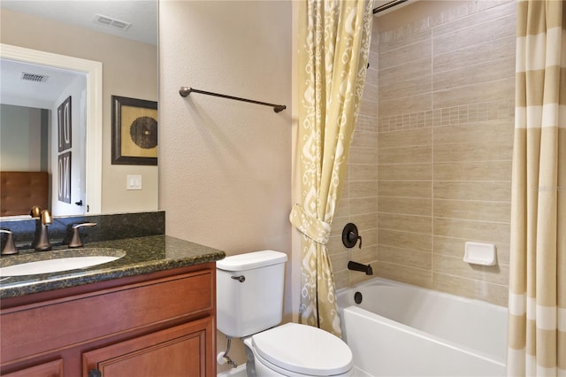 bathroom with shower / bath combo, visible vents, vanity, and toilet