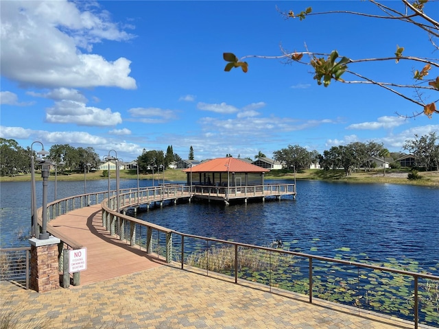 view of dock with a gazebo and a water view