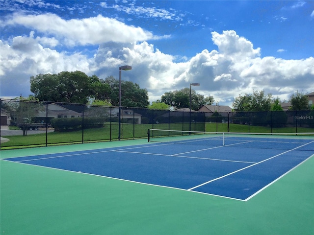 view of sport court with fence