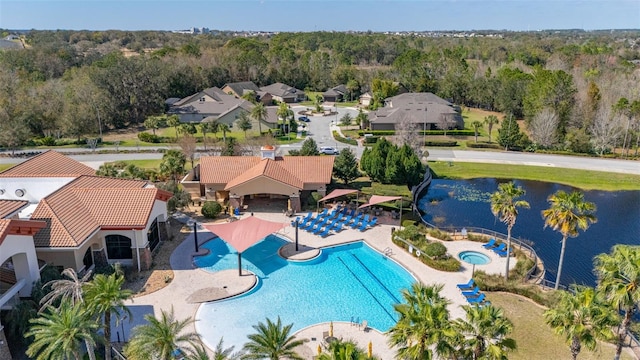 birds eye view of property with a forest view and a water view