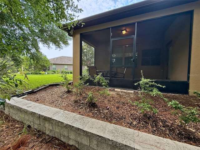 513 San Sebastian Ct, Davenport, FL 33837 - doorway to property with a lawn and stucco siding
