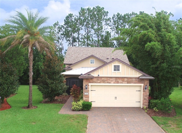 513 San Sebastian Ct, Davenport, FL 33837 - view of front of house featuring stone siding, decorative driveway, a front yard, and a shingled roof