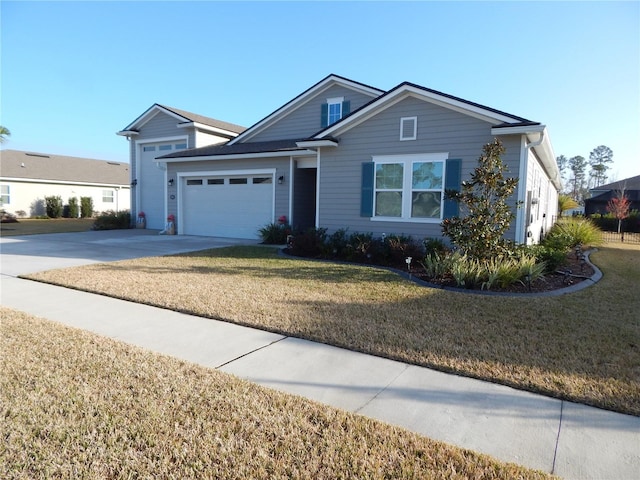 view of front of home featuring a front yard and a garage