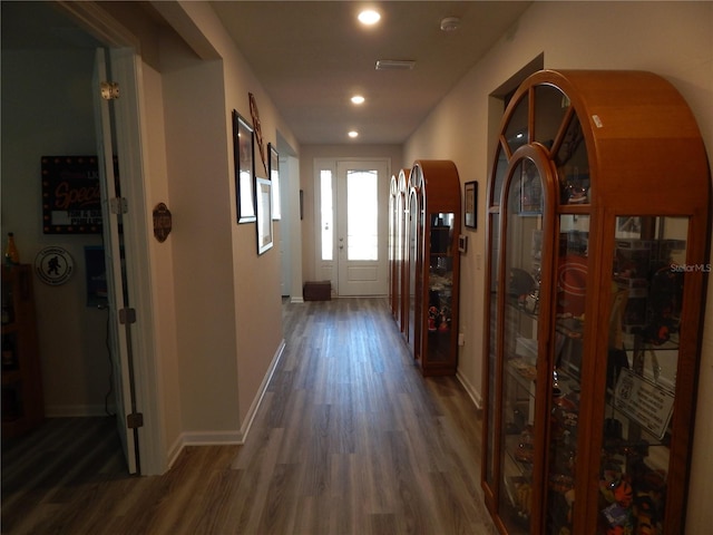 corridor featuring dark wood-type flooring