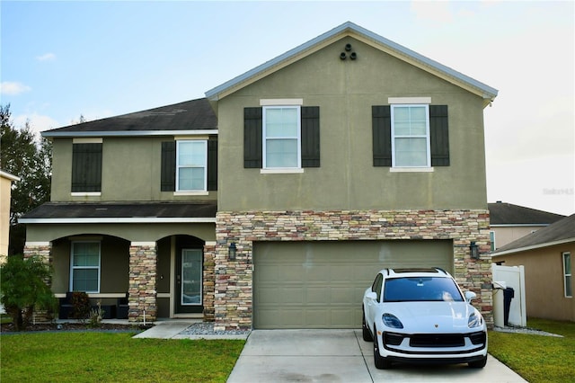 view of front of property with a front yard and a garage