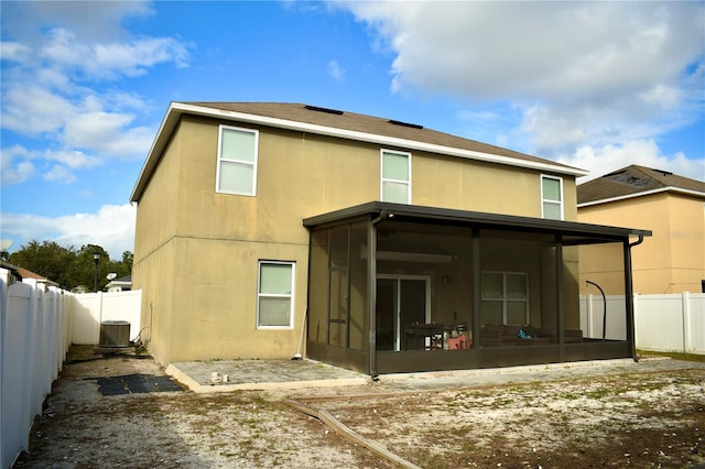 back of house featuring cooling unit and a sunroom