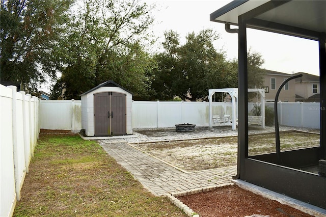 view of yard with a fire pit, a patio area, and a shed