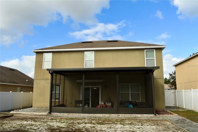 rear view of house with a sunroom