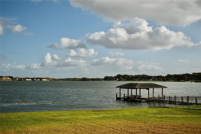 view of dock featuring a water view and a lawn