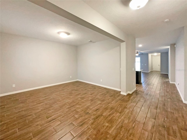 unfurnished room with ceiling fan and hardwood / wood-style flooring